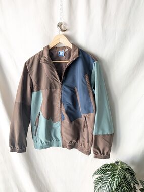Undefeated Jacket in Taupe and Beige with Blue Logo Tag